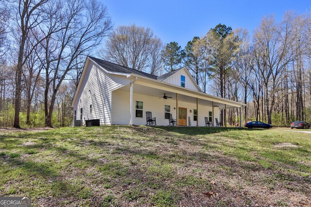 90 Jefferson Rd, Statham, GA 30666 - view of side of home with a yard, central AC unit, a ceiling fan, and board and batten siding
