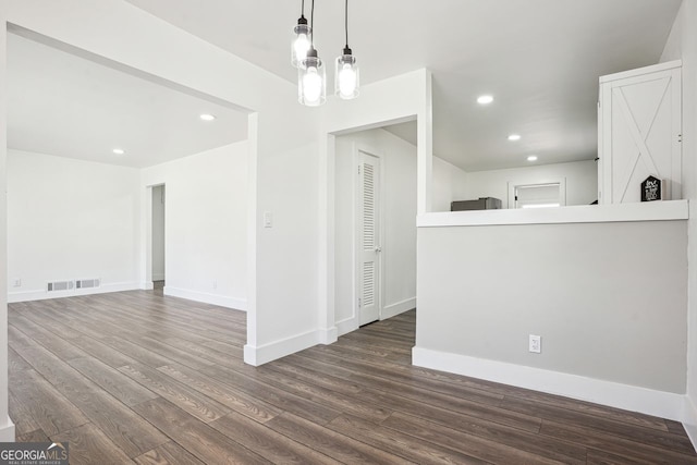 spare room with recessed lighting, wood finished floors, visible vents, and baseboards