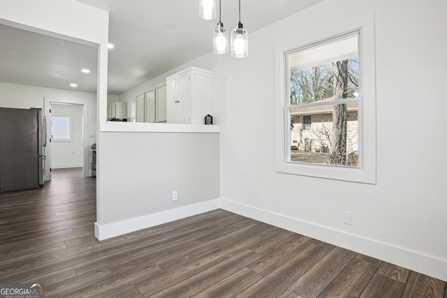 unfurnished dining area featuring dark wood-type flooring, recessed lighting, and baseboards