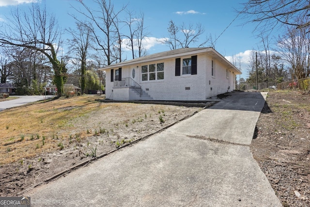 single story home featuring brick siding, crawl space, and fence