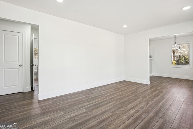 unfurnished room featuring dark wood-style floors, baseboards, and recessed lighting