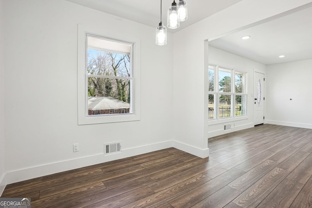 unfurnished dining area with dark wood-style floors, baseboards, visible vents, and recessed lighting