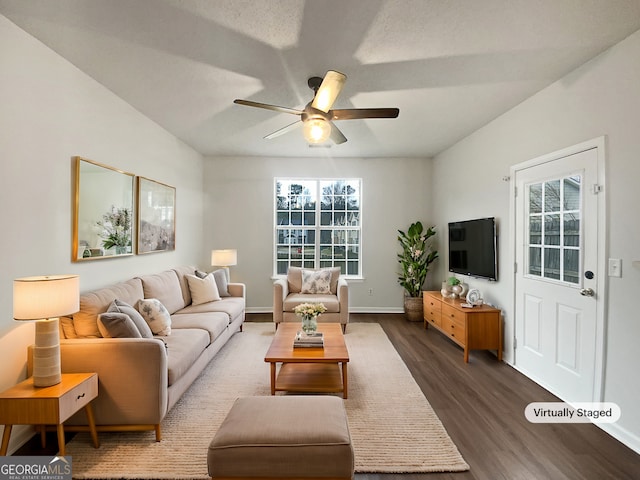 living room with a ceiling fan, plenty of natural light, baseboards, and wood finished floors