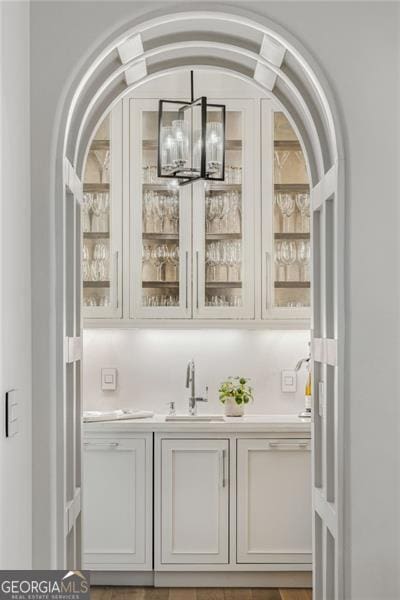 bar featuring indoor wet bar and a sink