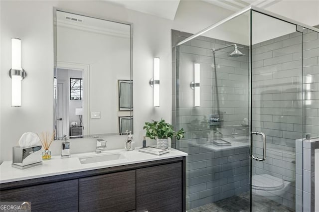 bathroom with vanity, visible vents, and a stall shower