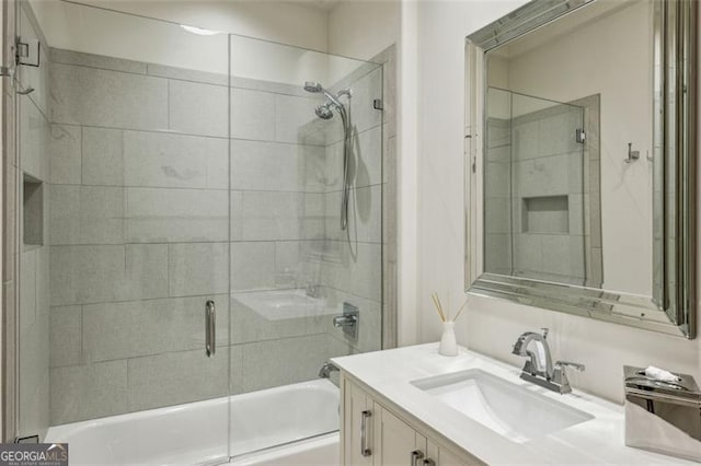 full bathroom featuring enclosed tub / shower combo and vanity