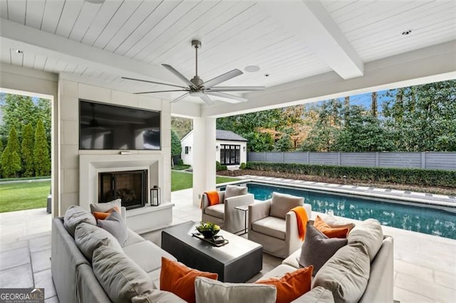 view of patio / terrace with a fenced in pool, an outdoor living space with a fireplace, ceiling fan, and fence