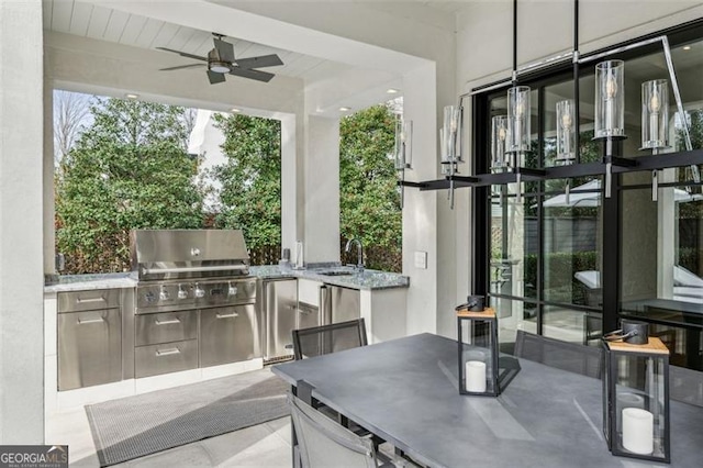 view of patio featuring ceiling fan, exterior kitchen, outdoor dining area, area for grilling, and a sink