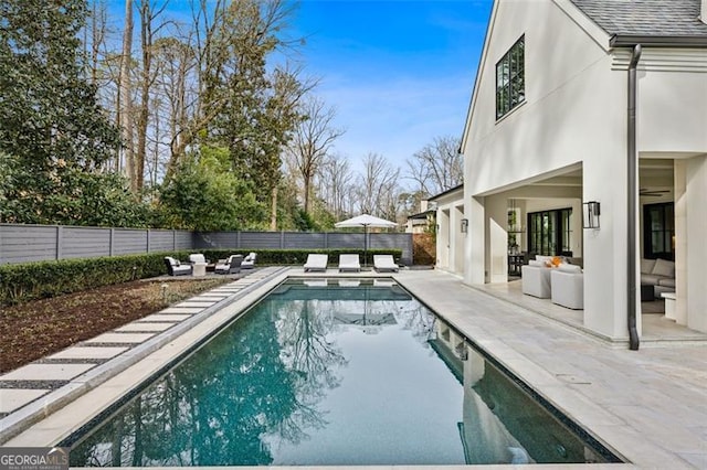 view of swimming pool featuring a fenced in pool, a fenced backyard, and a patio area