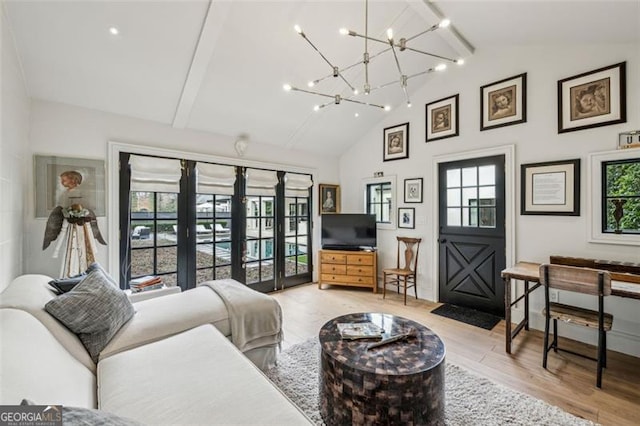 living room with a chandelier, beam ceiling, high vaulted ceiling, and light wood-style flooring