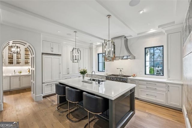 kitchen with a sink, a notable chandelier, a healthy amount of sunlight, and light countertops