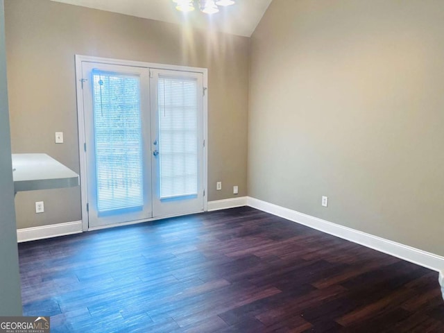 entryway featuring vaulted ceiling, baseboards, and wood finished floors