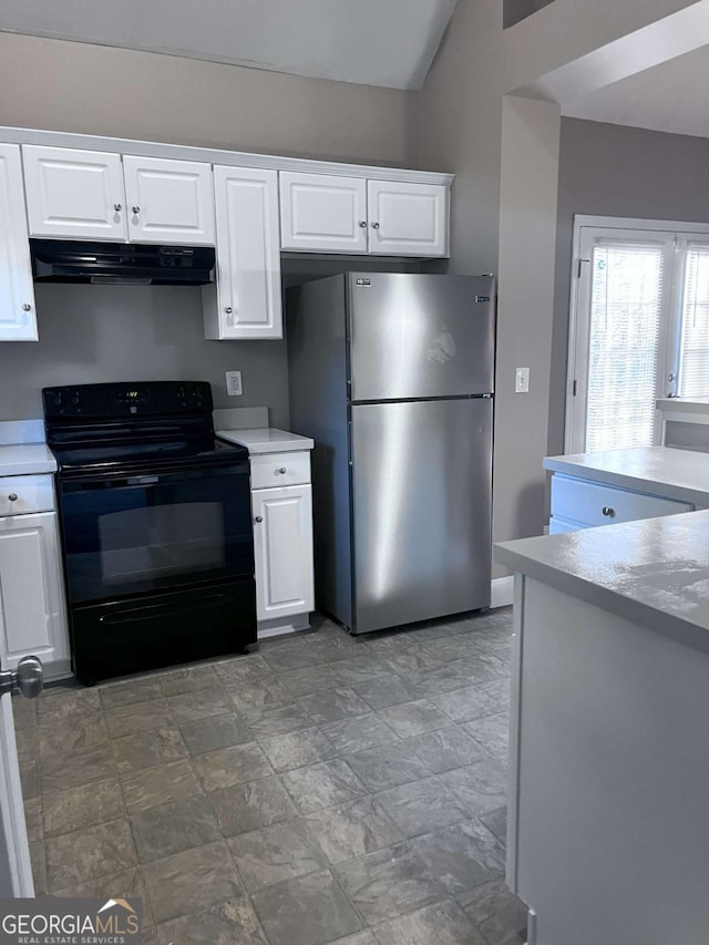 kitchen featuring light countertops, freestanding refrigerator, white cabinetry, black range with electric cooktop, and under cabinet range hood