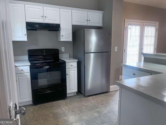 kitchen with black electric range oven, freestanding refrigerator, light countertops, under cabinet range hood, and white cabinetry