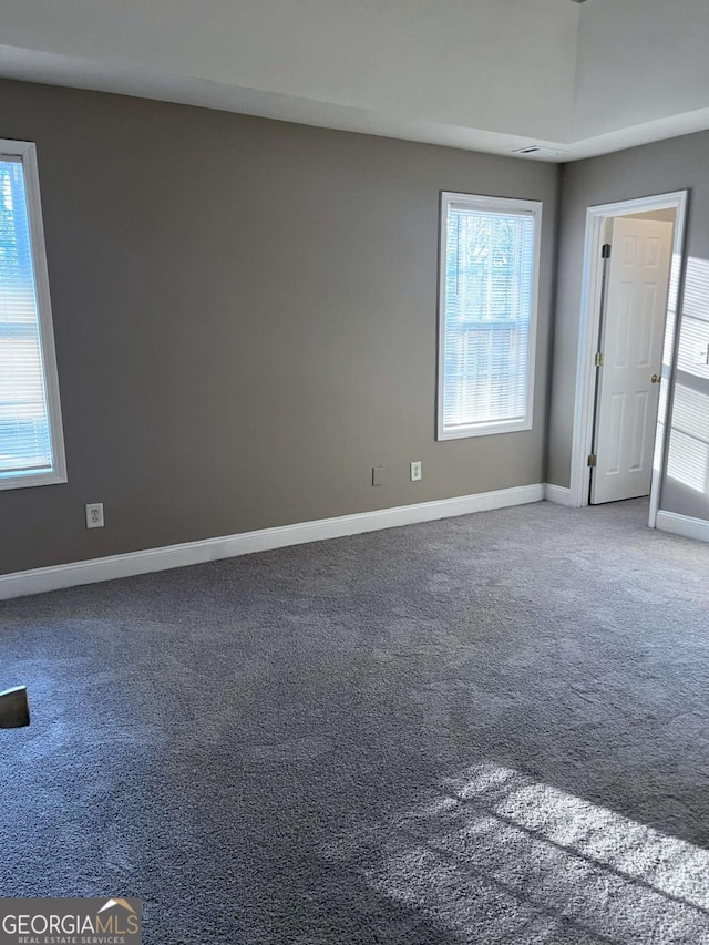 spare room with carpet and baseboards