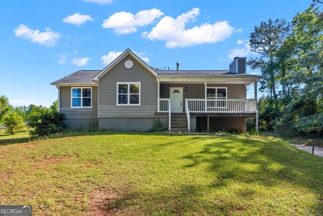 ranch-style house featuring a front yard, a porch, and a chimney