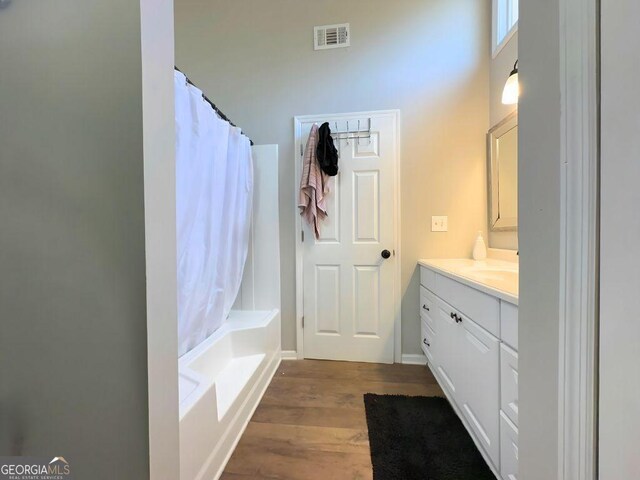 hall with dark wood-style flooring, baseboards, and an office area