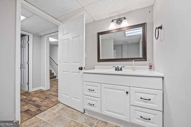 stairway with wood finished floors and baseboards