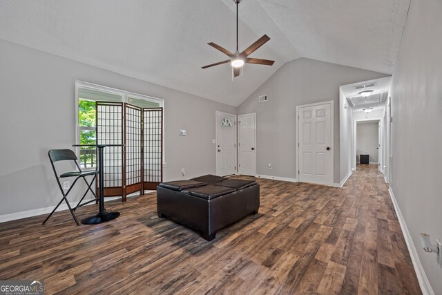 unfurnished living room featuring a ceiling fan, french doors, dark wood-type flooring, lofted ceiling, and baseboards