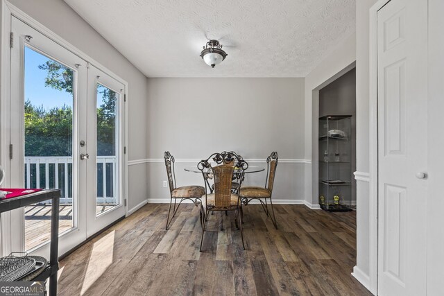 corridor featuring attic access, dark wood finished floors, and baseboards