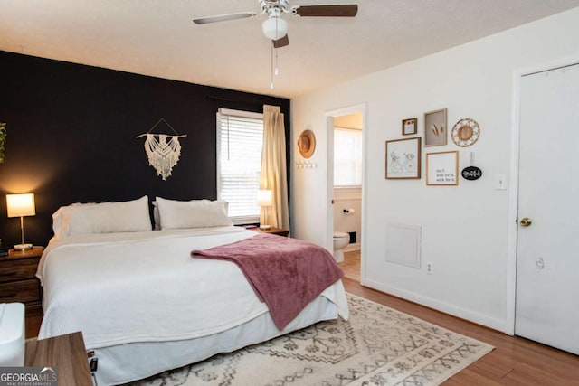 bedroom featuring ceiling fan, connected bathroom, and wood finished floors