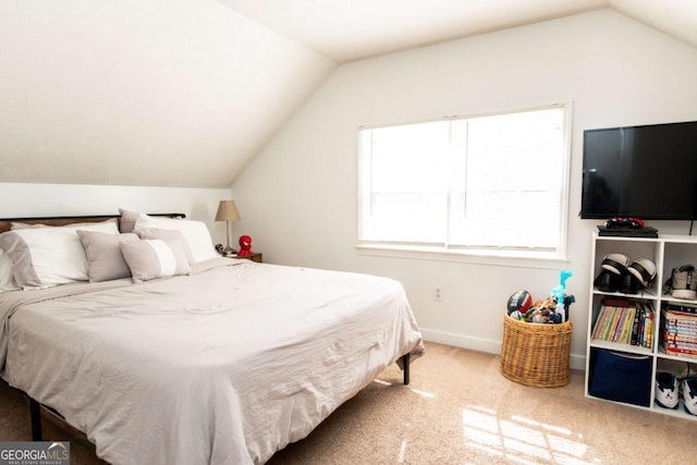 bedroom featuring lofted ceiling, carpet floors, and baseboards