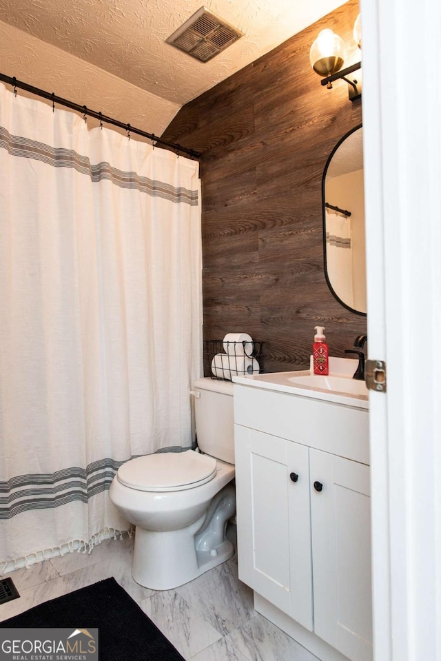 full bath with toilet, wooden walls, vanity, visible vents, and marble finish floor