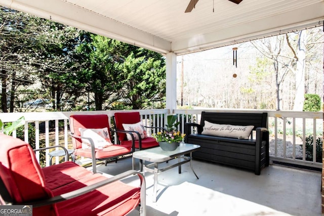 wooden terrace with outdoor lounge area and ceiling fan