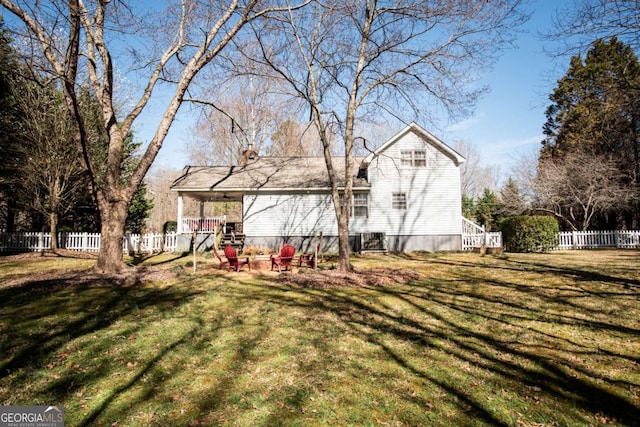 back of house with a yard and fence