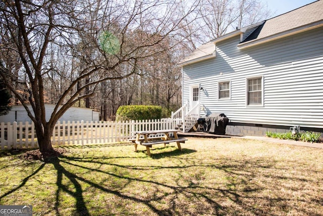 view of yard featuring entry steps and fence