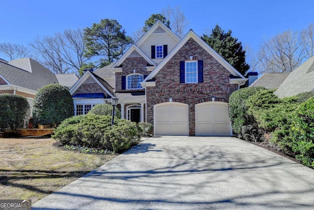 view of front of house featuring a garage, concrete driveway, and brick siding