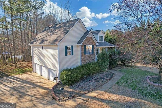 view of property exterior with concrete driveway and an attached garage