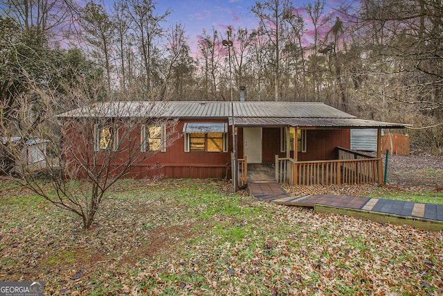 view of front of home with a porch and metal roof