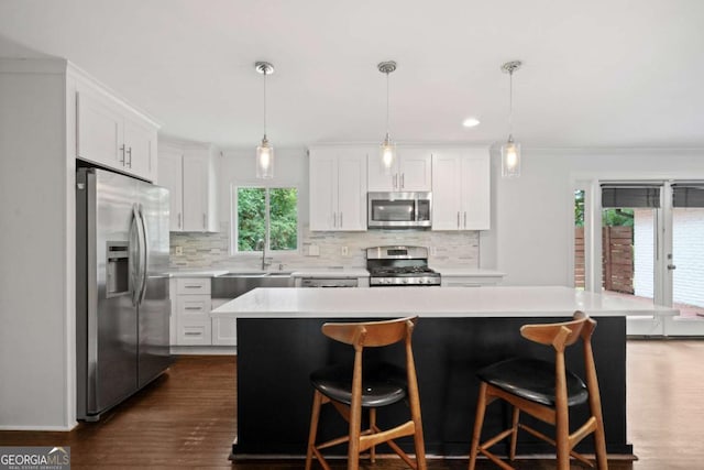 kitchen featuring white cabinetry, tasteful backsplash, appliances with stainless steel finishes, and light countertops