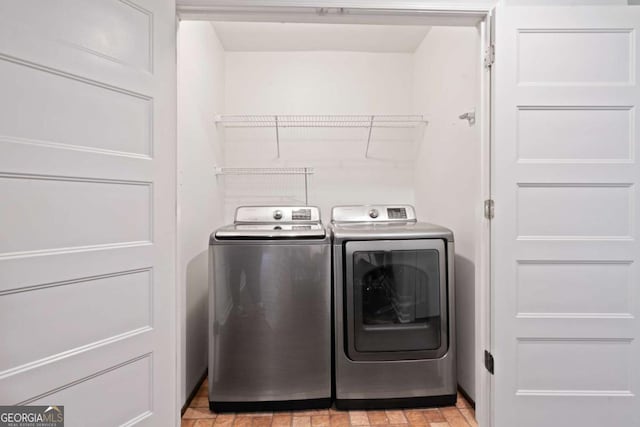 washroom featuring laundry area and independent washer and dryer