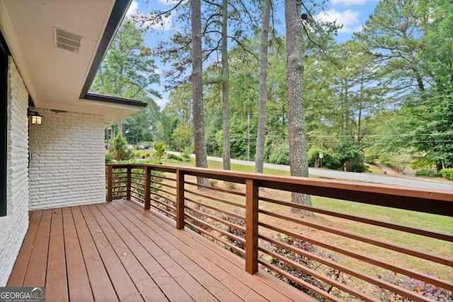 wooden deck featuring visible vents