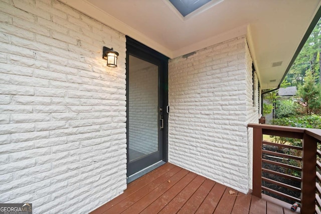 doorway to property with brick siding