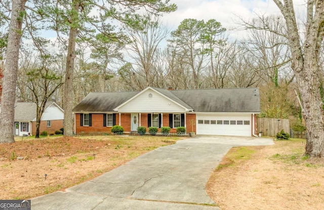 view of front facade featuring brick siding, a chimney, concrete driveway, an attached garage, and fence