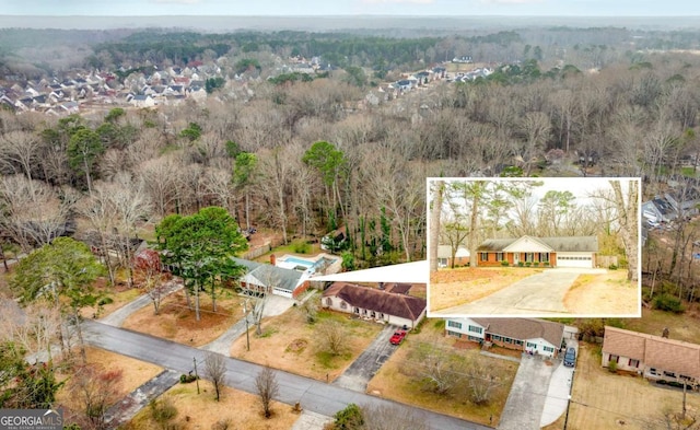 birds eye view of property featuring a view of trees