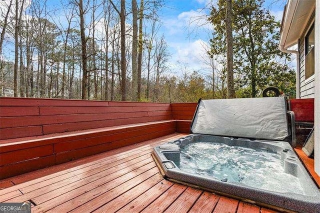 wooden deck with hot tub deck surround