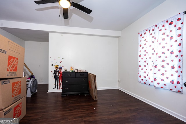 interior space with a ceiling fan, baseboards, and wood finished floors