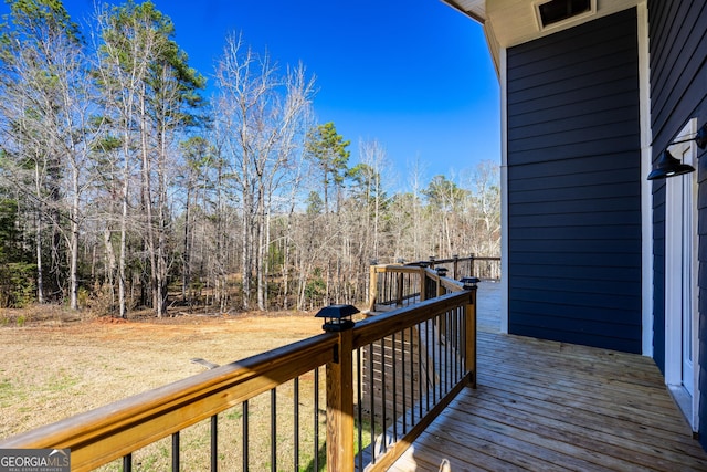 wooden terrace with a wooded view