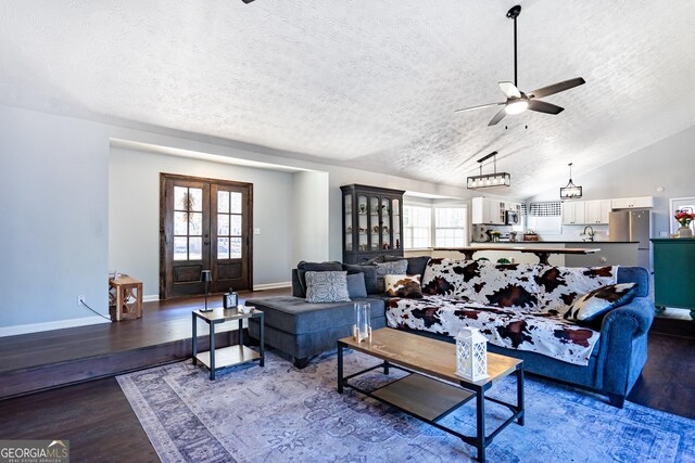 living room featuring french doors, wood finished floors, and a healthy amount of sunlight