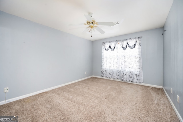 unfurnished room featuring baseboards, visible vents, carpet flooring, and a ceiling fan