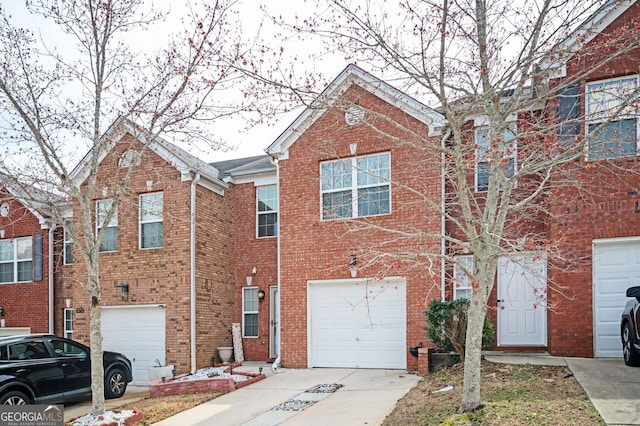 view of front of property with a garage, brick siding, and concrete driveway