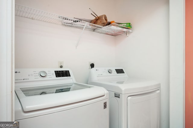 washroom featuring washer and clothes dryer and laundry area