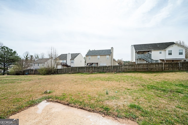 view of yard with a residential view and fence