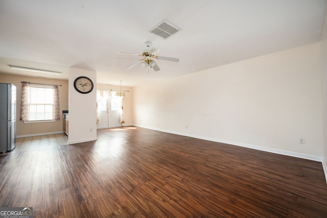 unfurnished living room with a ceiling fan, wood finished floors, visible vents, and baseboards