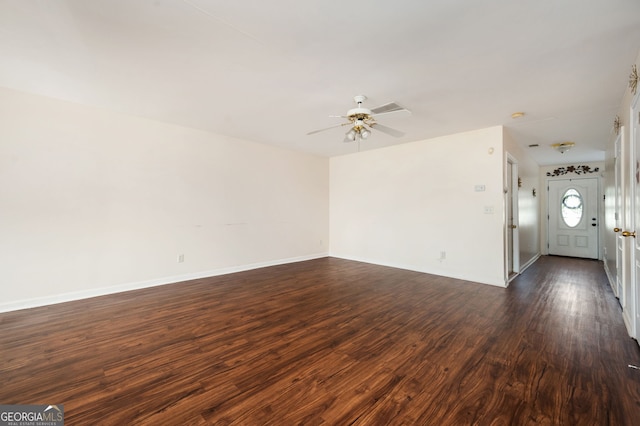 unfurnished living room with baseboards, a ceiling fan, and dark wood-style flooring