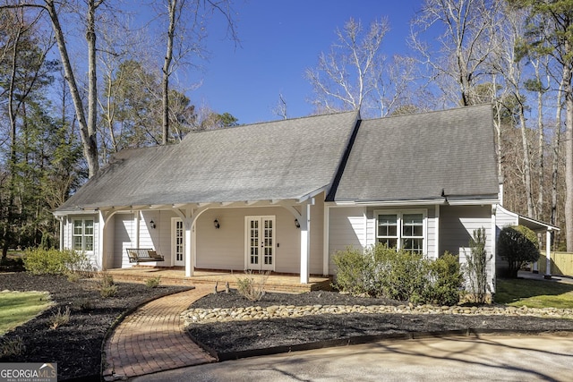 view of front of property with a front yard and french doors